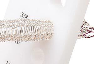 Knit wire being drawn through a drawplate